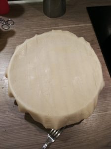 Plat recouvert de la pâte feuilletée, les bords dépassent