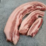 a pile of raw meat sitting on top of a cutting board