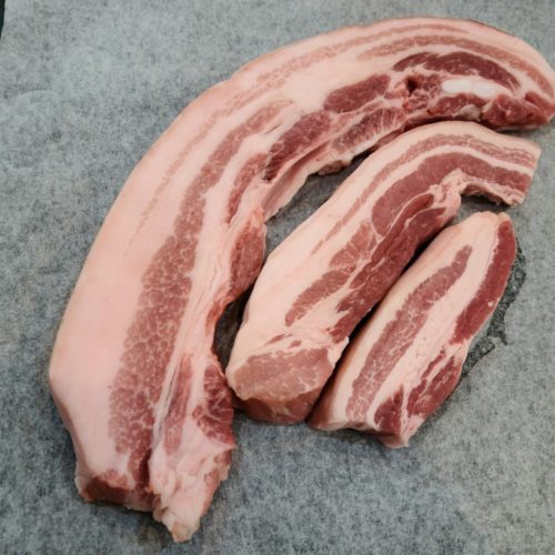 a pile of raw meat sitting on top of a cutting board